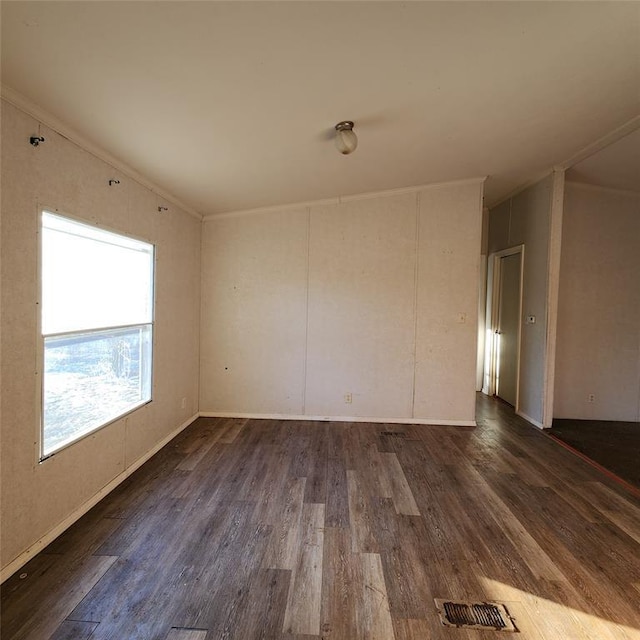 spare room featuring crown molding, visible vents, and dark wood-type flooring