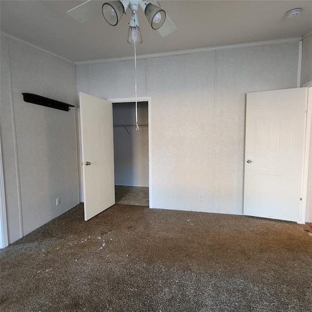 unfurnished bedroom featuring ornamental molding, carpet, and ceiling fan