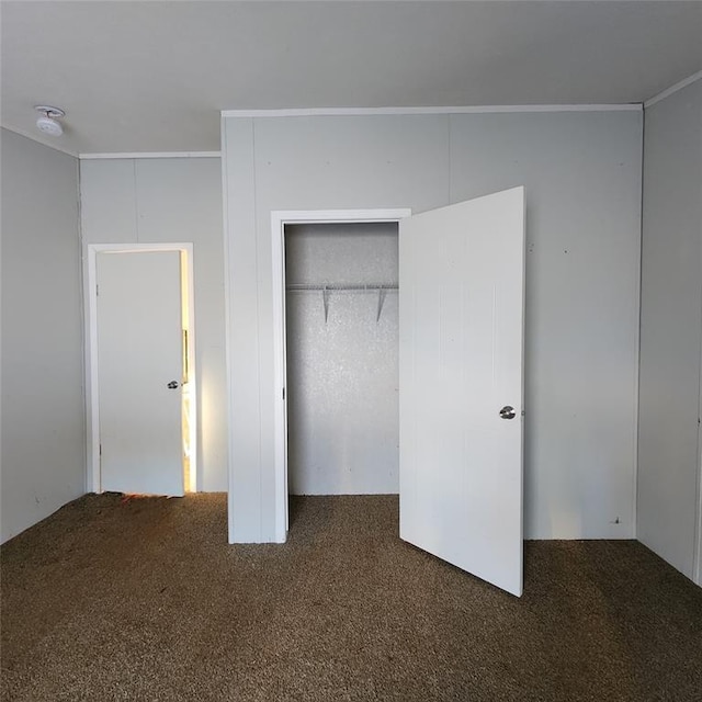 unfurnished bedroom featuring carpet floors and a closet