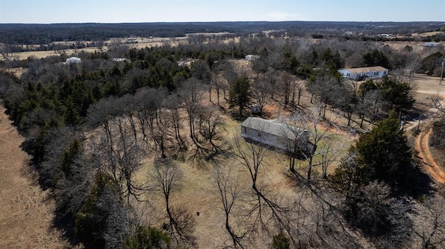 birds eye view of property featuring a view of trees