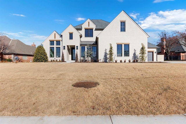 view of front of home featuring a garage and a front yard