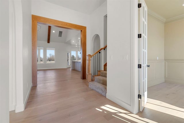 corridor featuring lofted ceiling with beams and light hardwood / wood-style floors