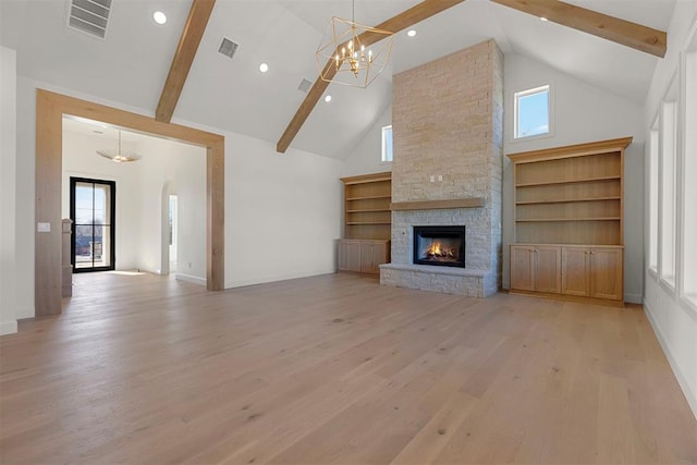 unfurnished living room featuring a fireplace, high vaulted ceiling, and a wealth of natural light