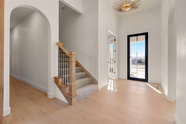 foyer with french doors and light hardwood / wood-style flooring