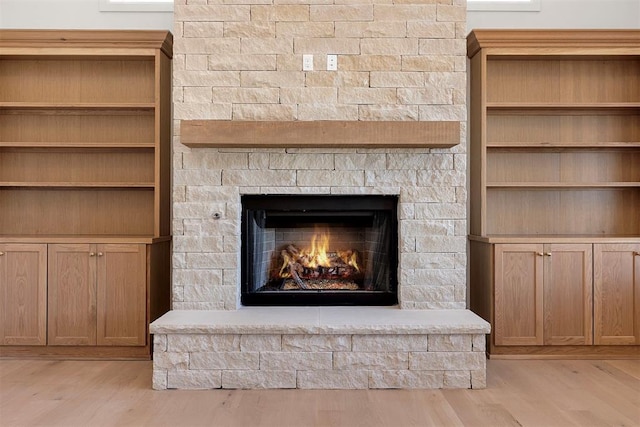 details featuring a stone fireplace and hardwood / wood-style floors