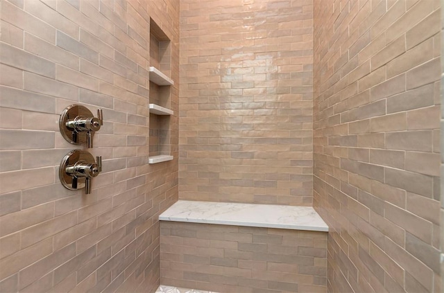 bathroom with a tile shower