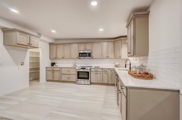 kitchen with lofted ceiling, sink, light brown cabinetry, tasteful backsplash, and stainless steel appliances