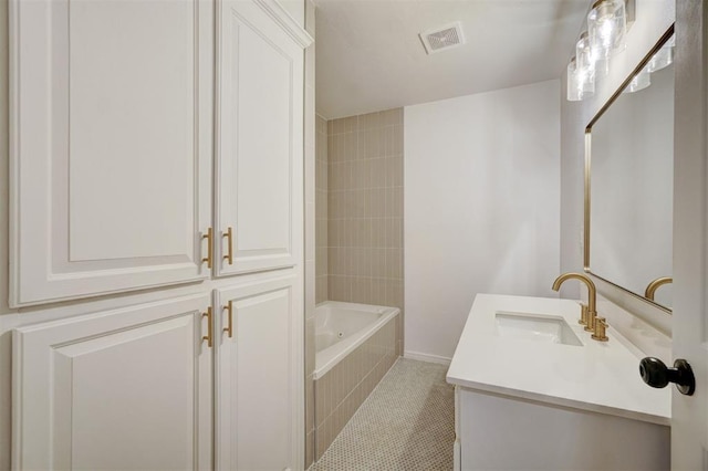 bathroom with tile patterned floors, vanity, and tiled shower / bath combo