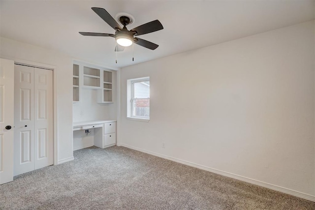 unfurnished bedroom with ceiling fan and light colored carpet