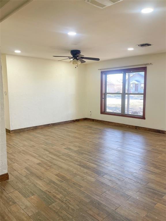 empty room with ceiling fan and wood-type flooring