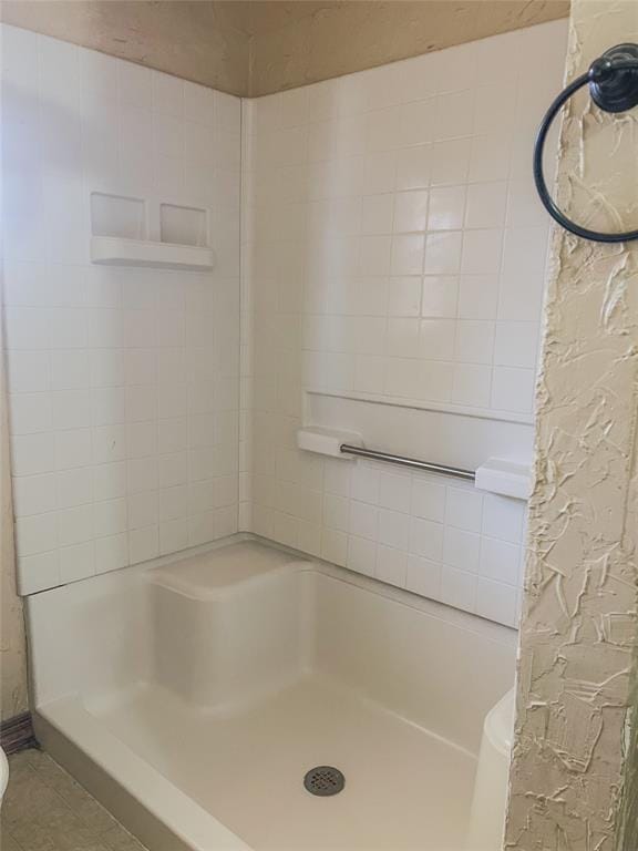 bathroom with walk in shower and tile patterned floors