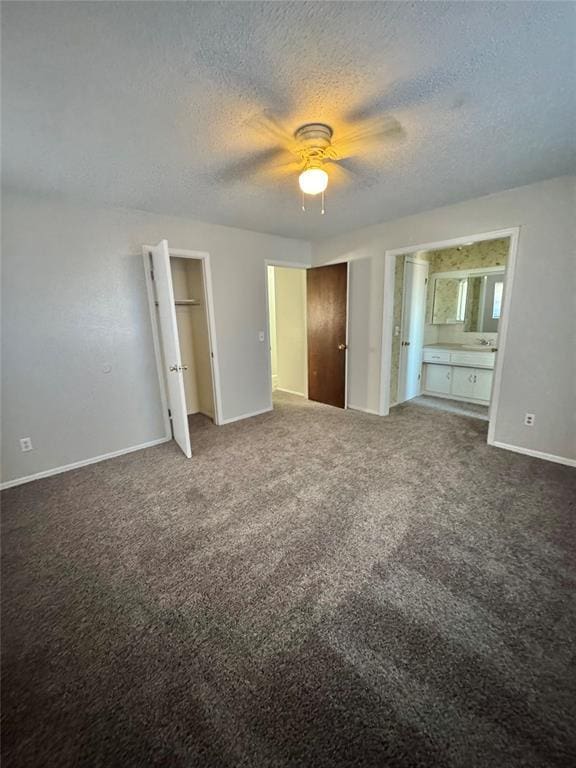 unfurnished bedroom featuring ceiling fan, carpet floors, and ensuite bathroom