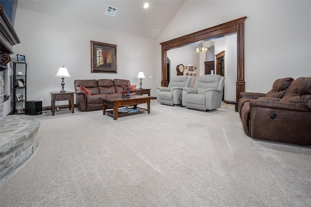 living room featuring carpet flooring, a notable chandelier, and high vaulted ceiling