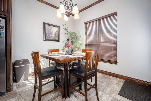 dining space with a chandelier and crown molding