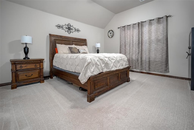 carpeted bedroom with lofted ceiling