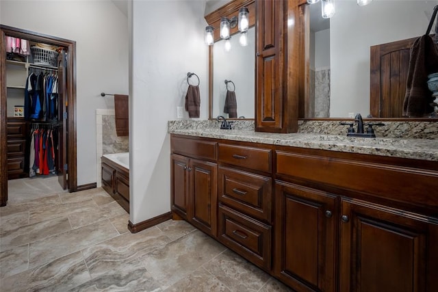 bathroom with a bathing tub and vanity