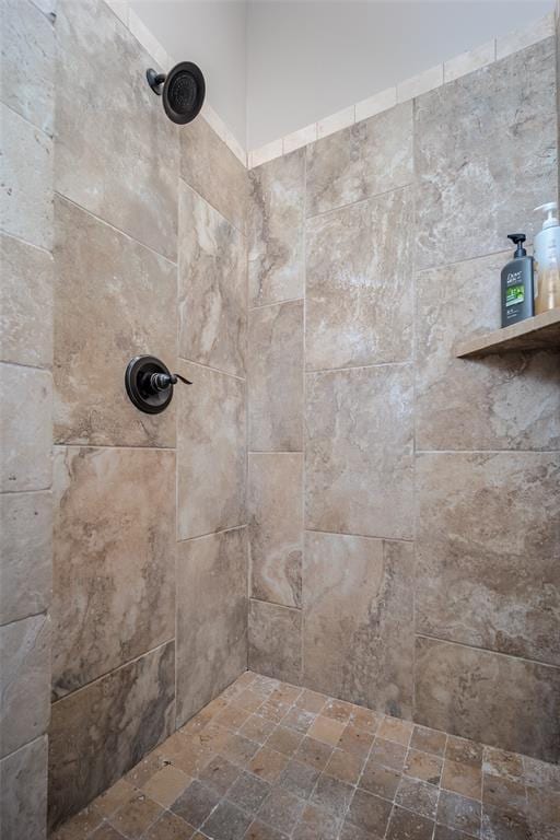 bathroom with a tile shower