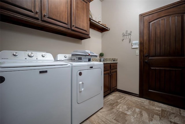 laundry area with washer and dryer and cabinets