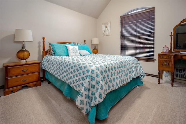 carpeted bedroom featuring lofted ceiling