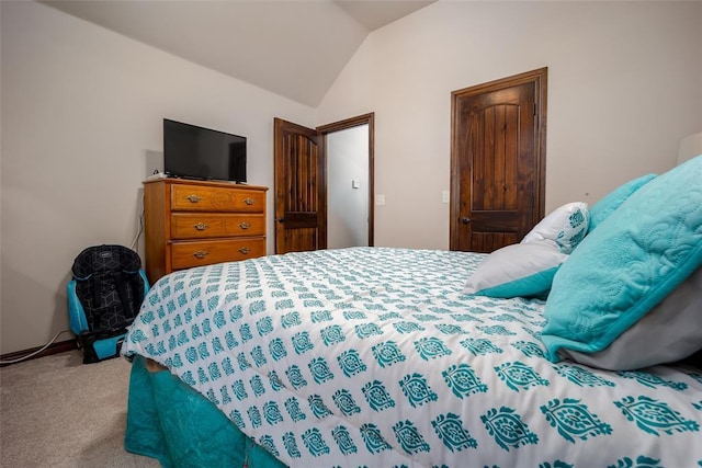 bedroom featuring carpet and lofted ceiling