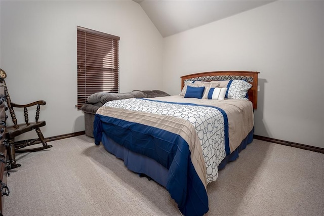 carpeted bedroom with lofted ceiling