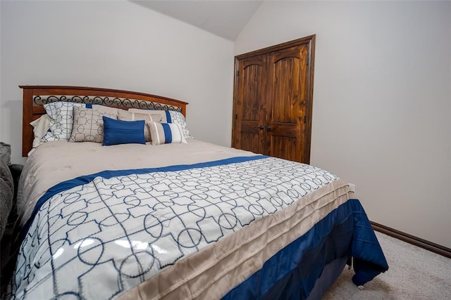 bedroom with carpet floors and vaulted ceiling