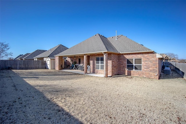 rear view of house featuring central AC unit and a patio area