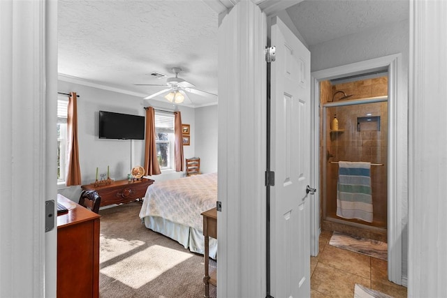 bedroom featuring ceiling fan, crown molding, light tile patterned flooring, and a textured ceiling