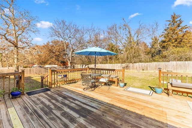 wooden terrace with a lawn