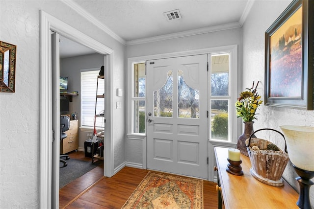 foyer with dark hardwood / wood-style floors and crown molding