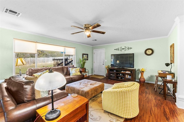 living room featuring dark hardwood / wood-style floors, ceiling fan, and crown molding