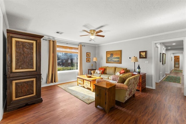 living room featuring ceiling fan, crown molding, and dark wood-type flooring