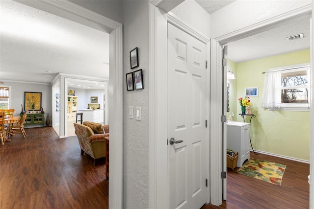 hall featuring dark hardwood / wood-style flooring and a textured ceiling