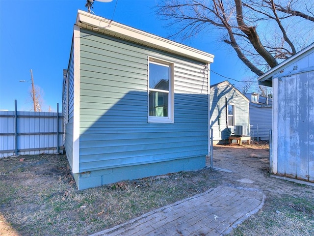 view of property exterior featuring central AC unit and an outdoor structure