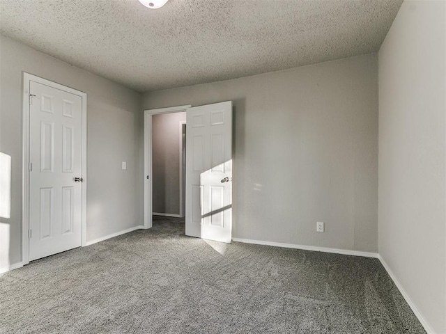 carpeted empty room with a textured ceiling