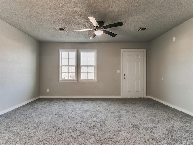 carpeted spare room featuring ceiling fan and a textured ceiling