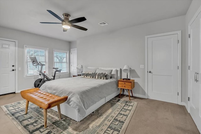 bedroom with light carpet, baseboards, visible vents, and ceiling fan