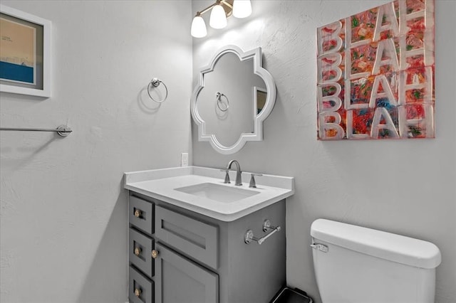 half bathroom with toilet and vanity