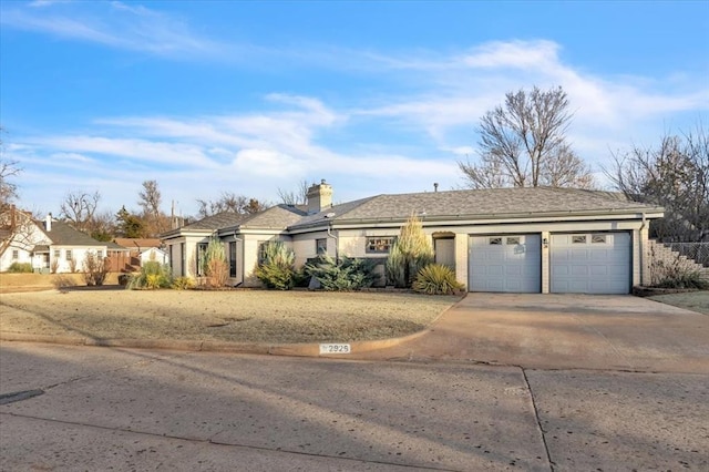 ranch-style home with driveway, a chimney, an attached garage, and fence