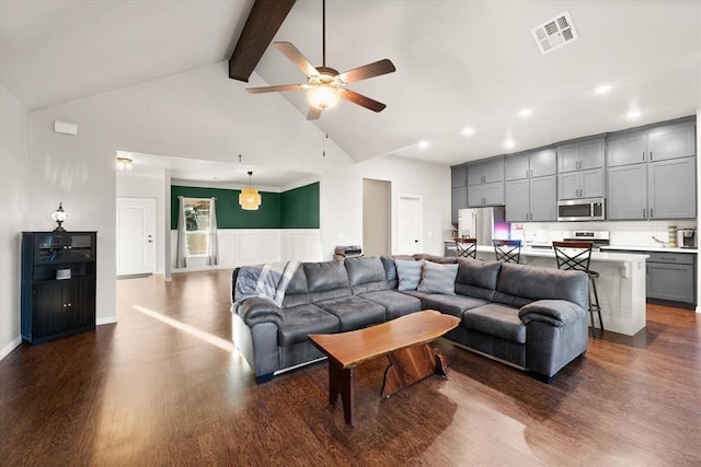 living room with ceiling fan, beam ceiling, dark wood-type flooring, and high vaulted ceiling