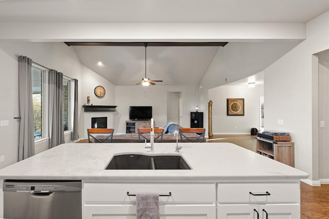 kitchen featuring white cabinets, vaulted ceiling, ceiling fan, sink, and dishwasher