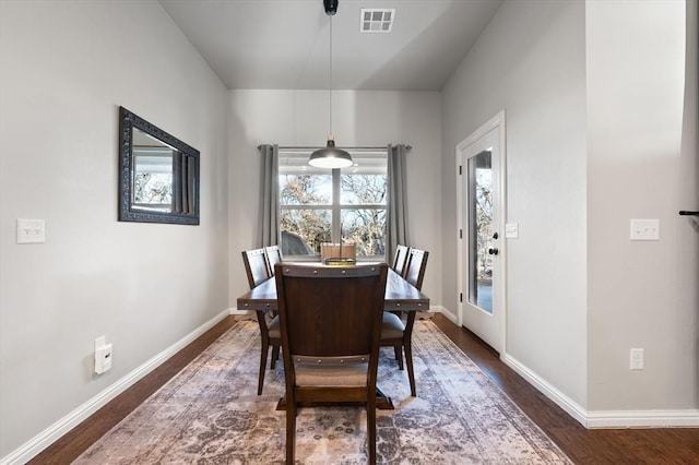 dining space featuring dark hardwood / wood-style flooring