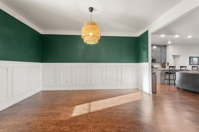 unfurnished dining area featuring dark hardwood / wood-style floors