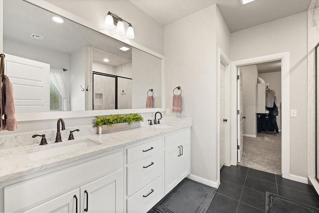 bathroom featuring tile patterned flooring, vanity, and a shower with shower door