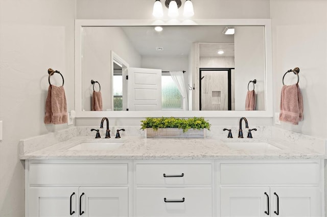 bathroom with vanity and a shower with shower door