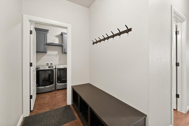 mudroom featuring washing machine and dryer and dark wood-type flooring