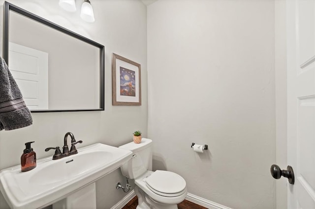 bathroom featuring toilet and sink