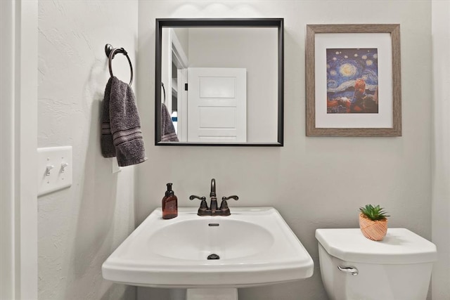 bathroom featuring sink and toilet