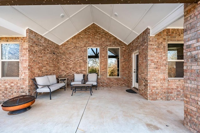 view of patio / terrace with an outdoor living space with a fire pit