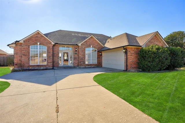 view of front of property featuring a front lawn and a garage